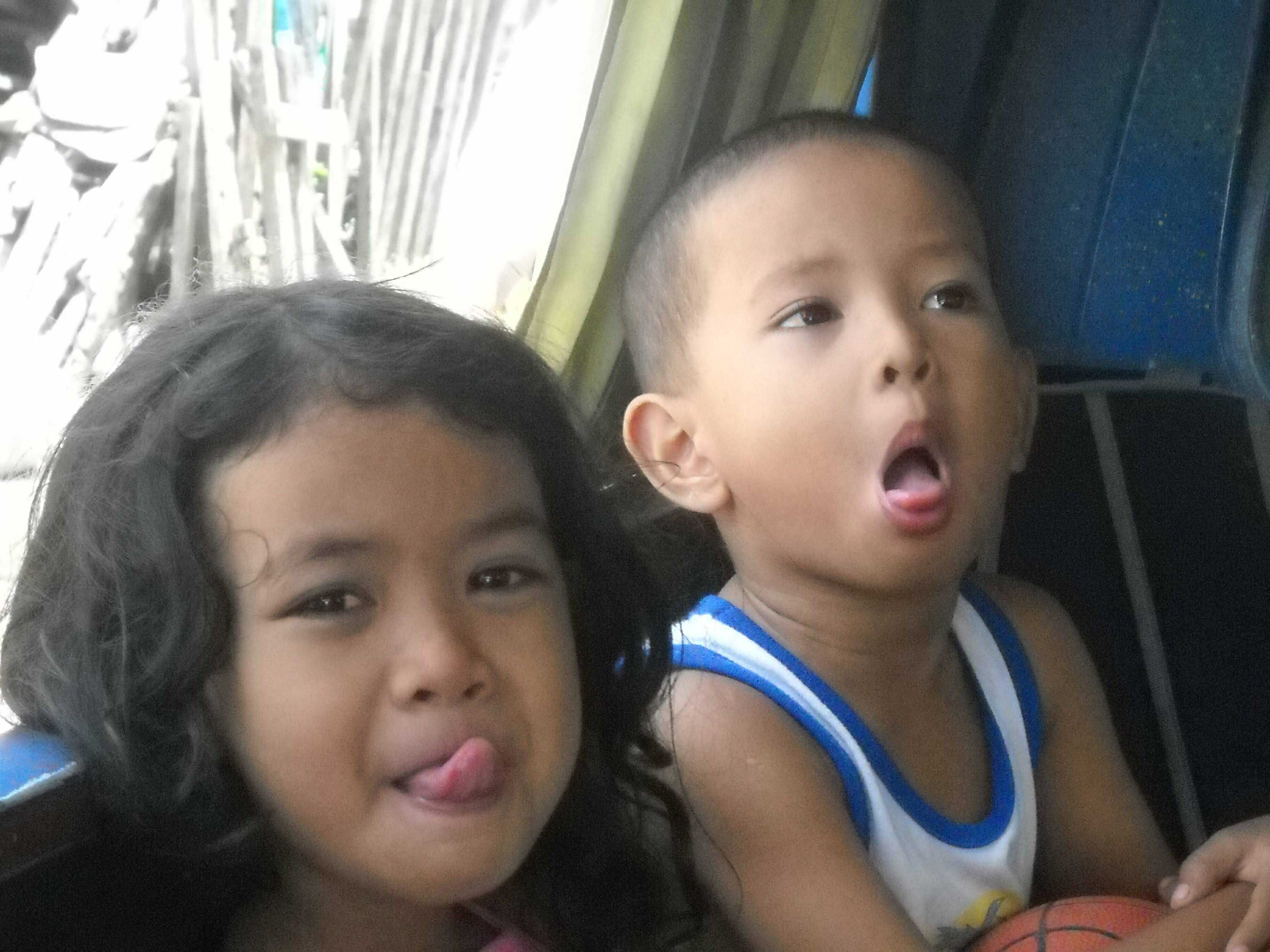 Crystal & Khan (her brother) clowning it up while sitting in Ado's (their father) Multi-Cab